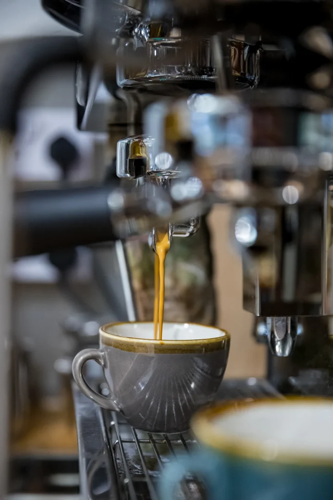 Coffee pouring from machine to cup