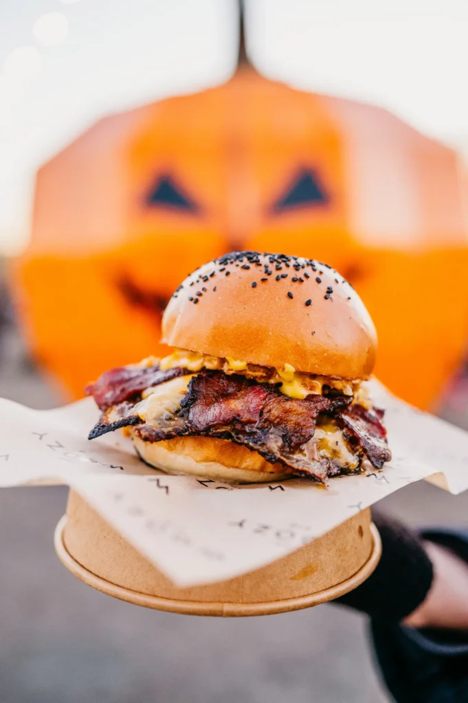 Burger in front of Pumpkin face