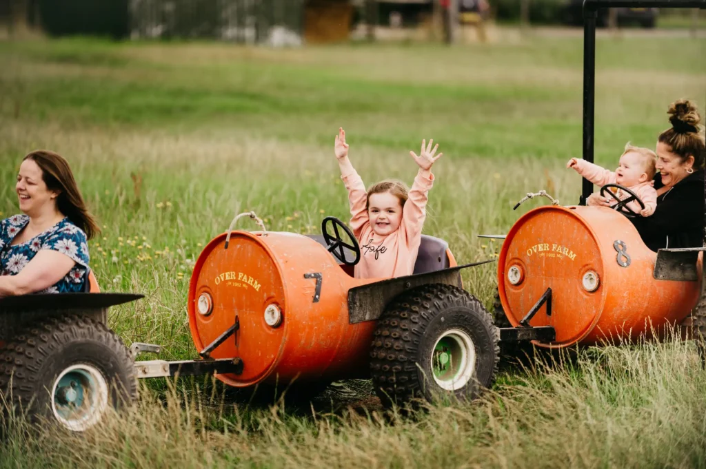 Quad Train with girl riding on it with arms in the air