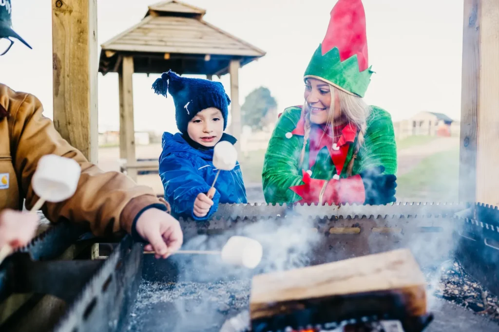 Child and Elf around marshmallow fire pit