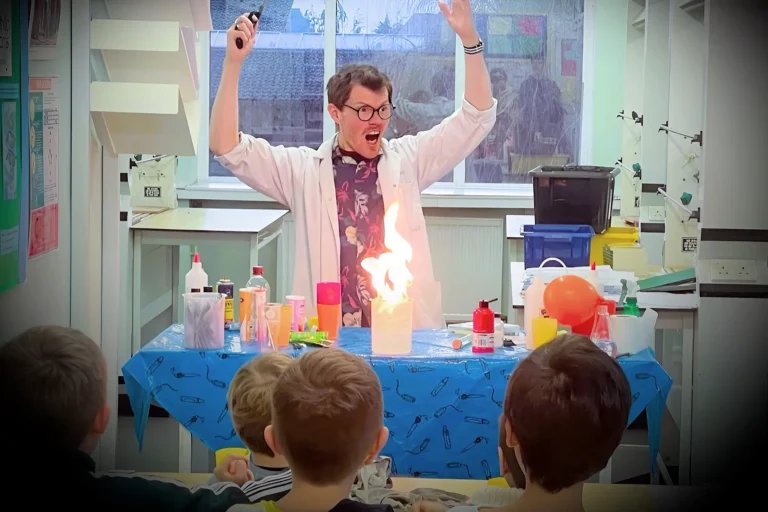 Diatom Dave shows off a flame to children in a classroom